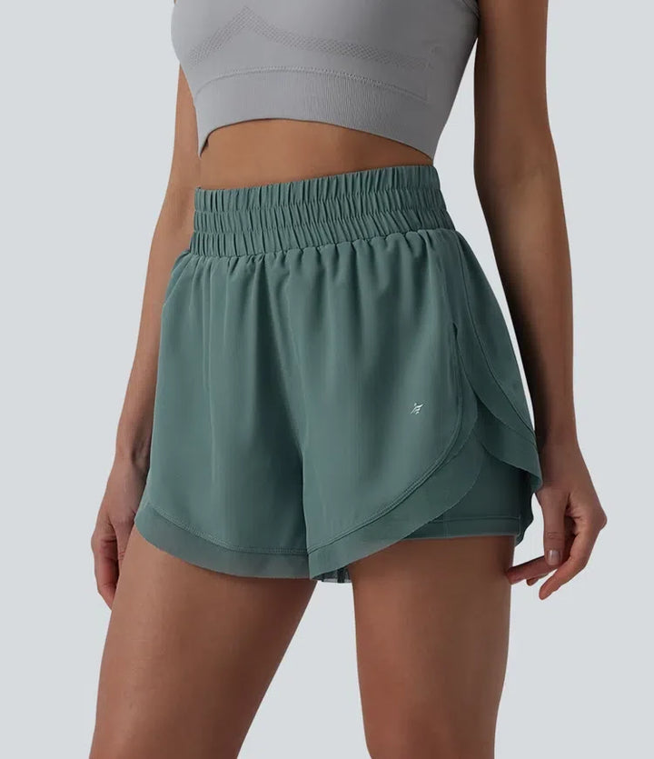 Med hög midja kontrastmesh 2-i-1 löpning shorts med fickor