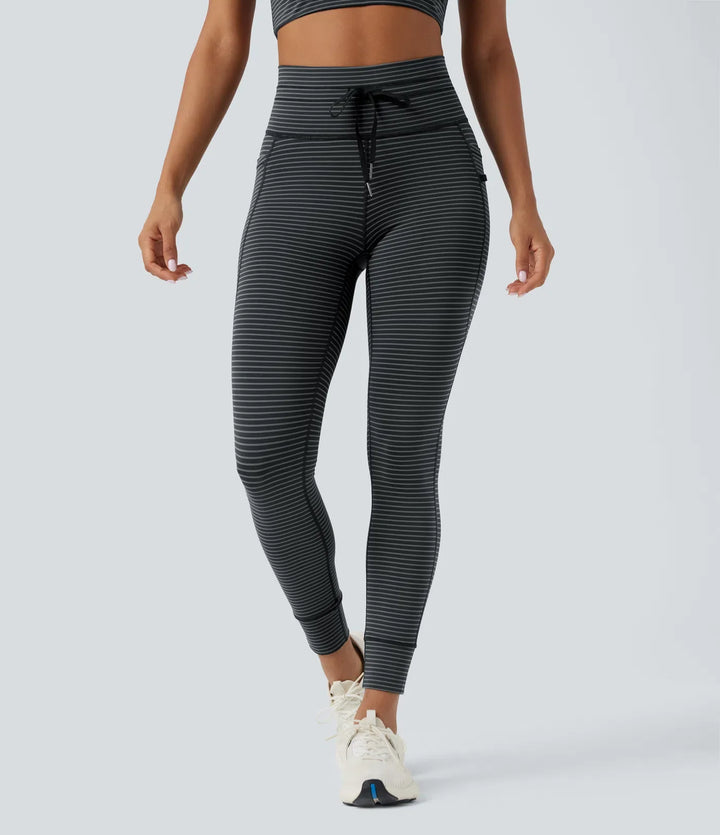 Högmidjad dragsko randig yogaleggings med fickor
