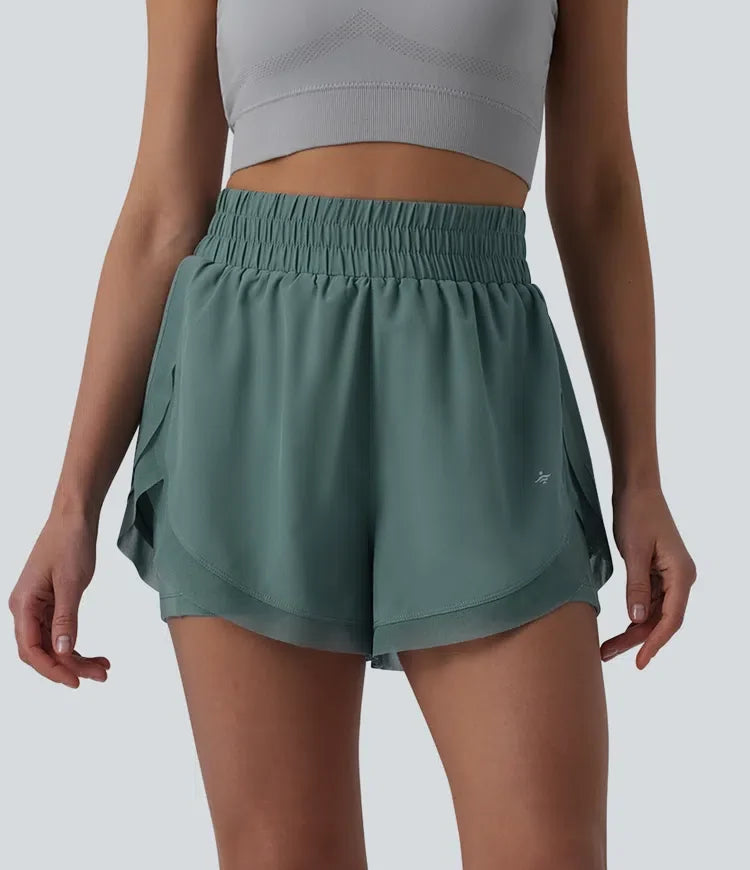 Med hög midja kontrastmesh 2-i-1 löpning shorts med fickor